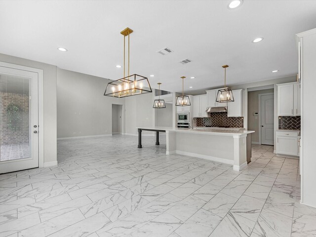 2107 Jitterbug Ln, Katy, TX 77493 - kitchen with light marble finish floors, open floor plan, tasteful backsplash, light countertops, and recessed lighting