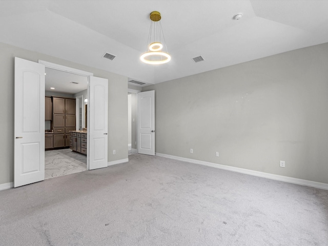 2107 Jitterbug Ln, Katy, TX 77493 - unfurnished bedroom featuring baseboards, light colored carpet, and ensuite bath