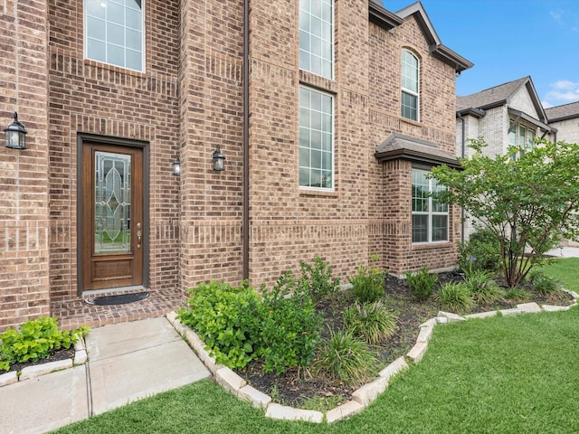 2107 Jitterbug Ln, Katy, TX 77493 - doorway to property featuring brick siding and a lawn
