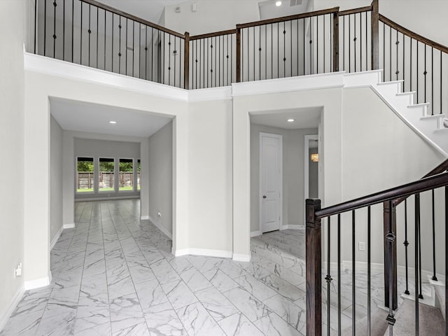 2107 Jitterbug Ln, Katy, TX 77493 - entryway featuring marble finish flooring, baseboards, stairs, a high ceiling, and recessed lighting