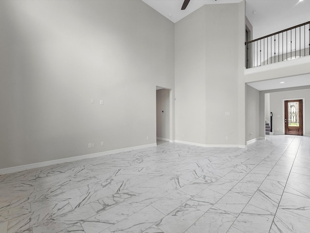 2107 Jitterbug Ln, Katy, TX 77493 - unfurnished living room with light marble finish flooring, high vaulted ceiling, ceiling fan, and baseboards