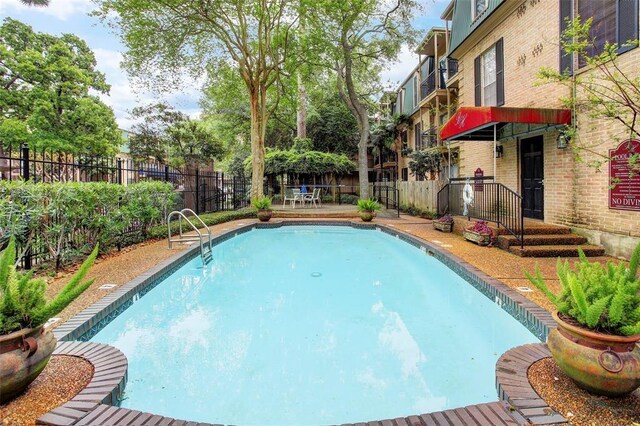 4515 Briar Hollow Pl Unit 213, Houston, TX 77027 - view of swimming pool with a fenced backyard