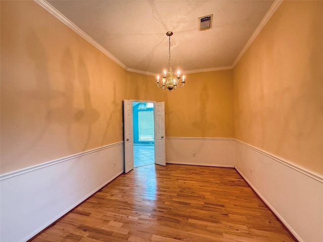 210 Cedar Lake Dr, League City, TX 77573 - spare room with a chandelier, wood finished floors, and crown molding