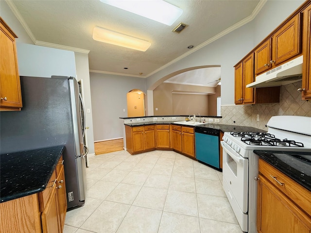 210 Cedar Lake Dr, League City, TX 77573 - kitchen featuring white range with gas stovetop, dishwashing machine, under cabinet range hood, freestanding refrigerator, and decorative backsplash