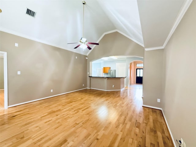 210 Cedar Lake Dr, League City, TX 77573 - unfurnished living room with light wood-style floors, a ceiling fan, arched walkways, lofted ceiling, and crown molding
