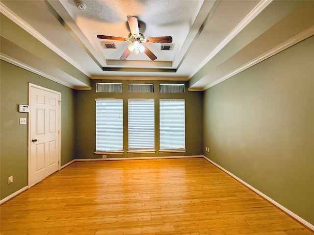 210 Cedar Lake Dr, League City, TX 77573 - spare room with a raised ceiling, ceiling fan, a smoke detector, ornamental molding, and light wood-style floors