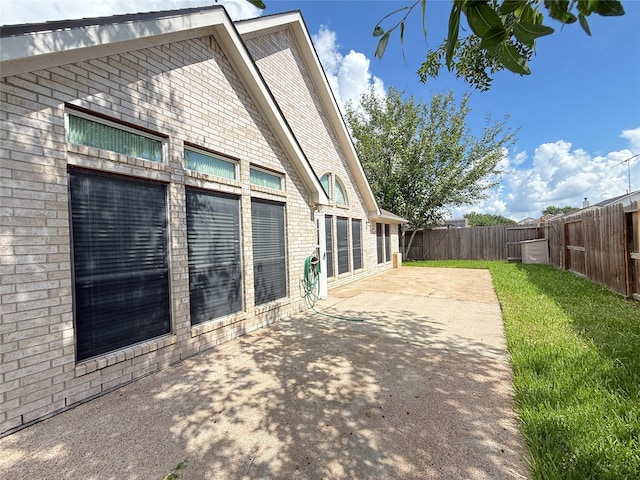 210 Cedar Lake Dr, League City, TX 77573 - view of side of property featuring a patio area, a fenced backyard, and brick siding