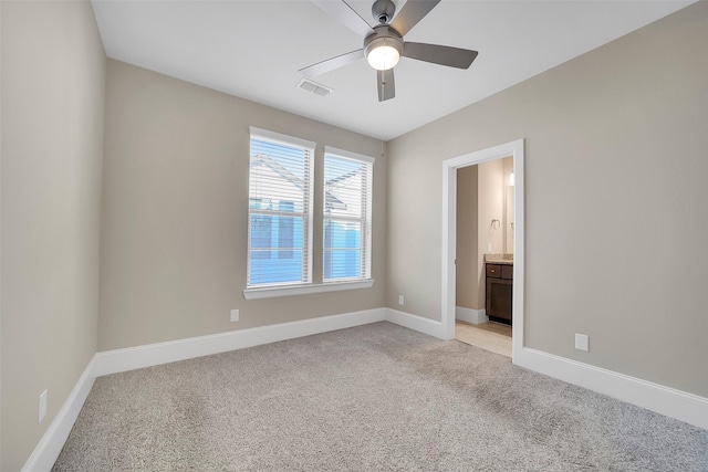 5401 Larkin St, Houston, TX 77007 - empty room featuring light carpet, a ceiling fan, and baseboards
