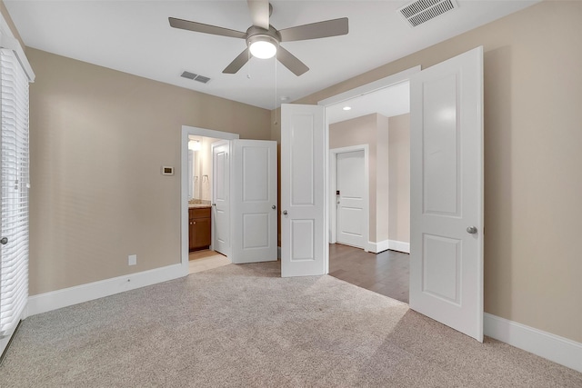 5401 Larkin St, Houston, TX 77007 - unfurnished bedroom with light carpet, baseboards, connected bathroom, and a ceiling fan