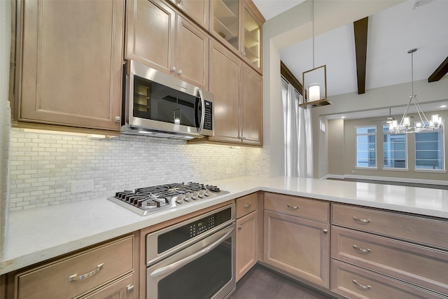 5401 Larkin St, Houston, TX 77007 - kitchen featuring stainless steel appliances, light countertops, a chandelier, tasteful backsplash, and glass insert cabinets
