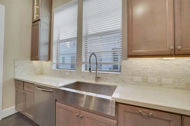 5401 Larkin St, Houston, TX 77007 - kitchen with a sink, dishwasher, backsplash, glass insert cabinets, and baseboards