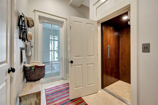 714 Positano Rd, Galveston, TX 77550 - entryway with elevator and light tile patterned floors