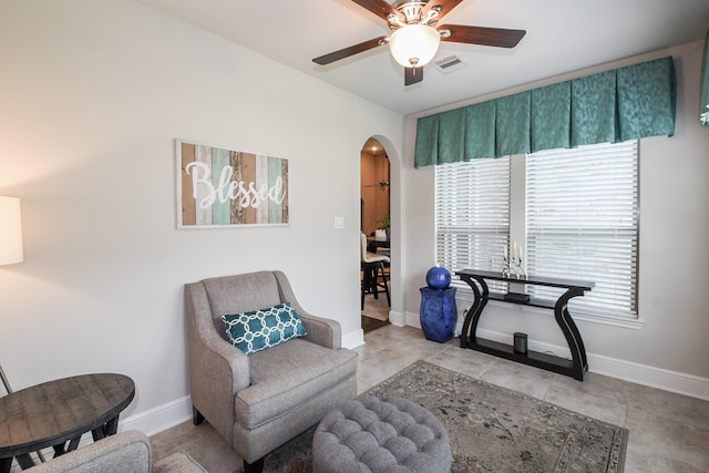 13326 Hartford Bay Trl, Cypress, TX 77429 - living area featuring arched walkways, ceiling fan, and healthy amount of natural light