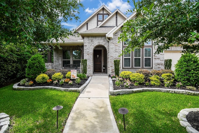 13326 Hartford Bay Trl, Cypress, TX 77429 - view of front of house with a front lawn, a shingled roof, covered porch, and brick siding