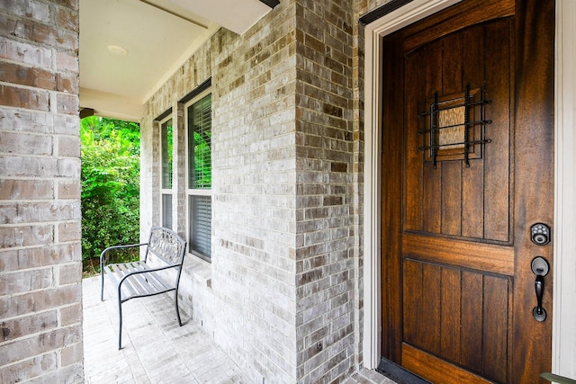 13326 Hartford Bay Trl, Cypress, TX 77429 - doorway to property featuring brick siding and a porch