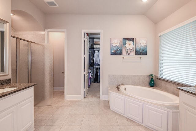 13326 Hartford Bay Trl, Cypress, TX 77429 - full bathroom with a shower stall, a bath, vanity, tile patterned flooring, and vaulted ceiling