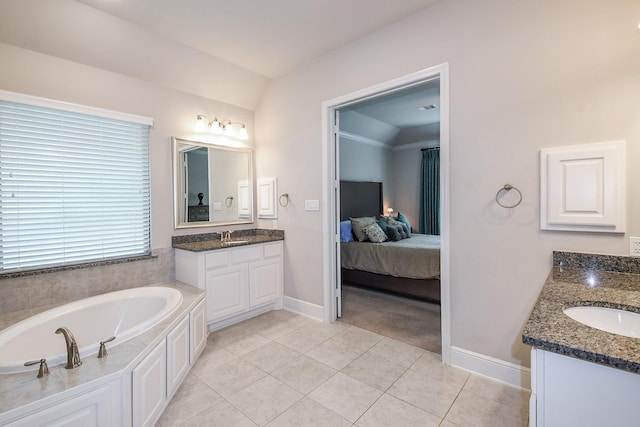 13326 Hartford Bay Trl, Cypress, TX 77429 - ensuite bathroom with two vanities, tile patterned floors, and a garden tub