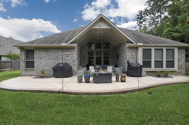 13326 Hartford Bay Trl, Cypress, TX 77429 - back of property with brick siding, a patio area, and an outdoor fire pit