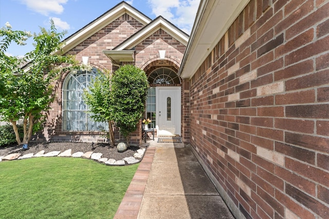 6318 Pleasant Stream Dr, Katy, TX 77449 - view of exterior entry with brick siding and a yard