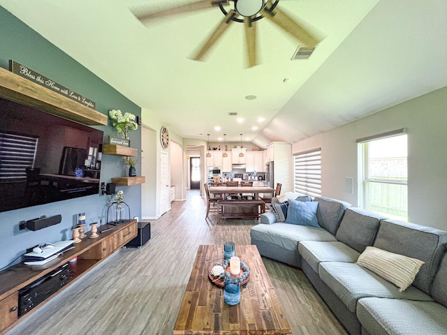 2900 Green Ash Ct, Conroe, TX 77301 - living area featuring lofted ceiling, ceiling fan, light wood finished floors, and baseboards