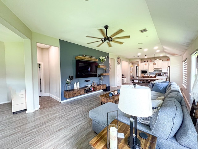2900 Green Ash Ct, Conroe, TX 77301 - living room with a ceiling fan, light wood-style flooring, baseboards, and lofted ceiling