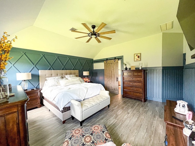 2900 Green Ash Ct, Conroe, TX 77301 - bedroom with lofted ceiling, wood finished floors, a wainscoted wall, and ceiling fan