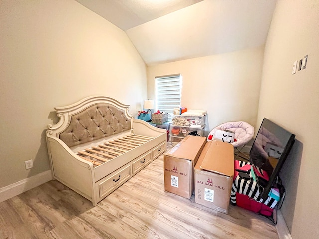 2900 Green Ash Ct, Conroe, TX 77301 - bedroom featuring wood finished floors, vaulted ceiling, and baseboards