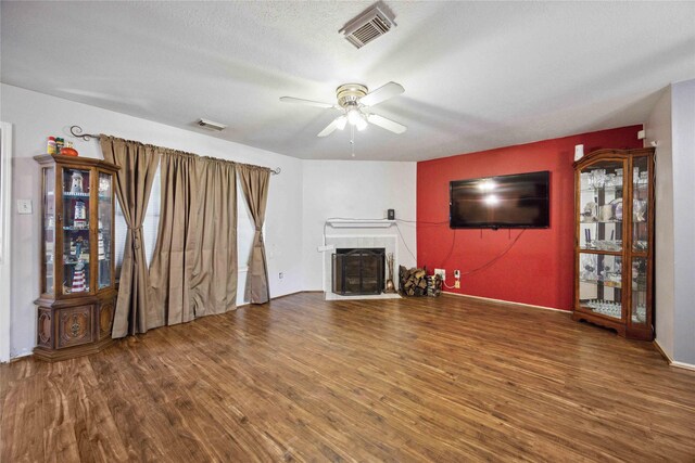 8202 Caddo Rd, Houston, TX 77078 - unfurnished living room featuring wood finished floors, ceiling fan, and a fireplace