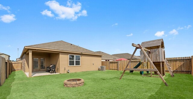 20730 Solstice Point Dr, Hockley, TX 77447 - rear view of property featuring french doors, a fire pit, a patio area, a playground, and central AC unit