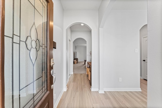 20730 Solstice Point Dr, Hockley, TX 77447 - entrance foyer with light wood-style floors, arched walkways, and baseboards