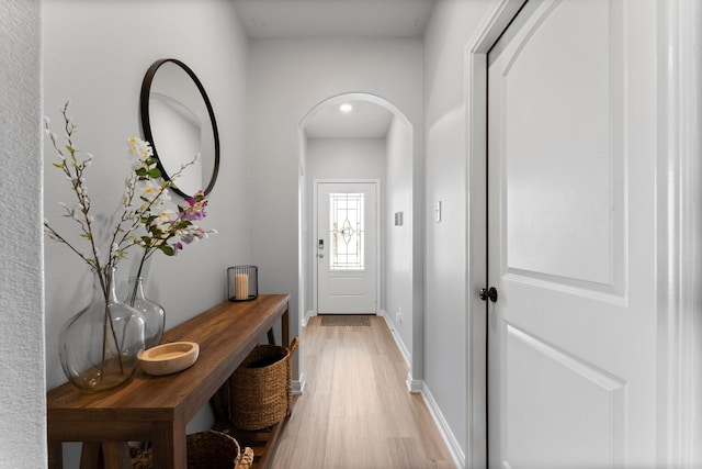 20730 Solstice Point Dr, Hockley, TX 77447 - entryway with light wood finished floors, arched walkways, and baseboards
