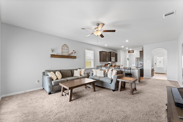 20730 Solstice Point Dr, Hockley, TX 77447 - living area featuring ceiling fan, light carpet, baseboards, arched walkways, and recessed lighting