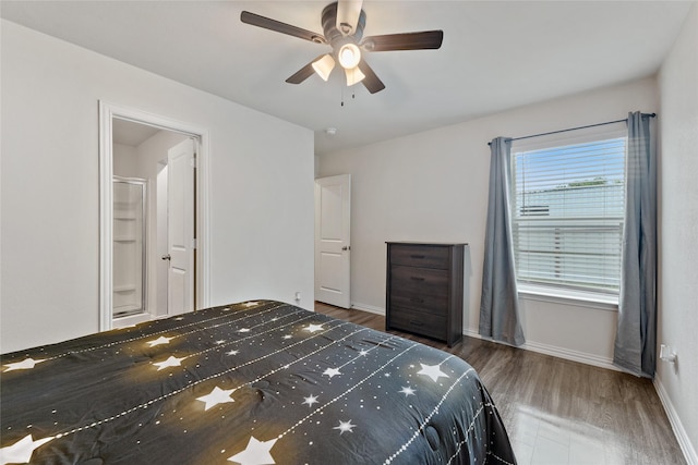 302 Connecticut St, Houston, TX 77029 - bedroom with wood finished floors, baseboards, a ceiling fan, and connected bathroom