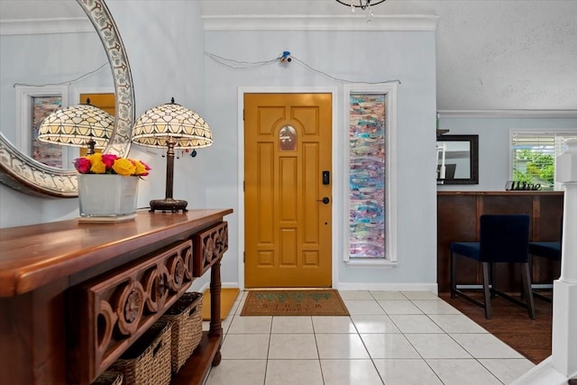 8307 Parasol Ln, Houston, TX 77064 - entrance foyer featuring light tile patterned floors, baseboards, ornamental molding, and a textured ceiling