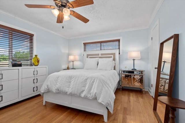 8307 Parasol Ln, Houston, TX 77064 - bedroom with multiple windows, light wood-style floors, crown molding, ceiling fan, and baseboards