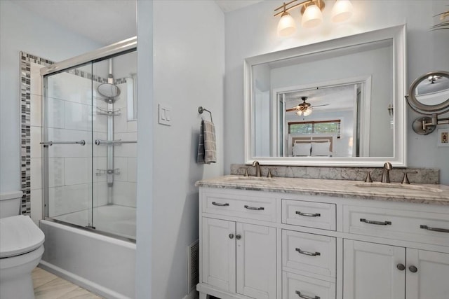 8307 Parasol Ln, Houston, TX 77064 - full bathroom with toilet, double vanity, shower / bath combination with glass door, and ceiling fan