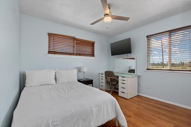 8307 Parasol Ln, Houston, TX 77064 - bedroom with wood finished floors, baseboards, a textured ceiling, and ceiling fan