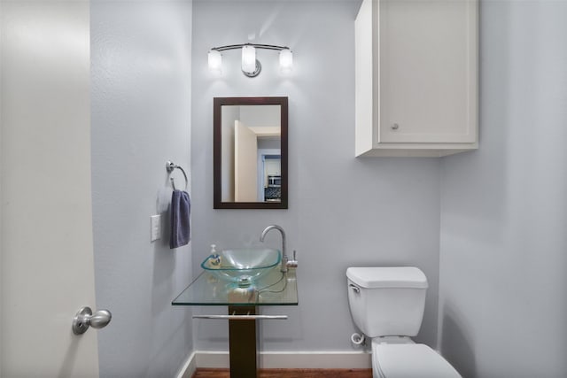 5810 Darling St Unit B, Houston, TX 77007 - bathroom featuring toilet, a sink, baseboards, and wood finished floors