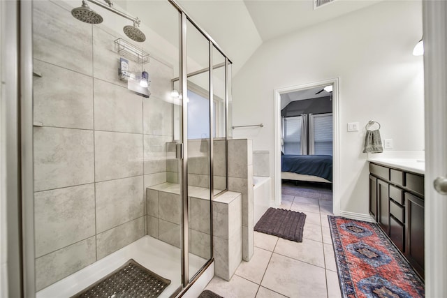 7411 Nottington Ct, Spring, TX 77379 - full bathroom with a stall shower, vaulted ceiling, ensuite bathroom, tile patterned floors, and a garden tub