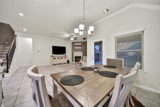 7411 Nottington Ct, Spring, TX 77379 - dining space with light tile patterned floors, a chandelier, ornamental molding, stairway, and a lit fireplace