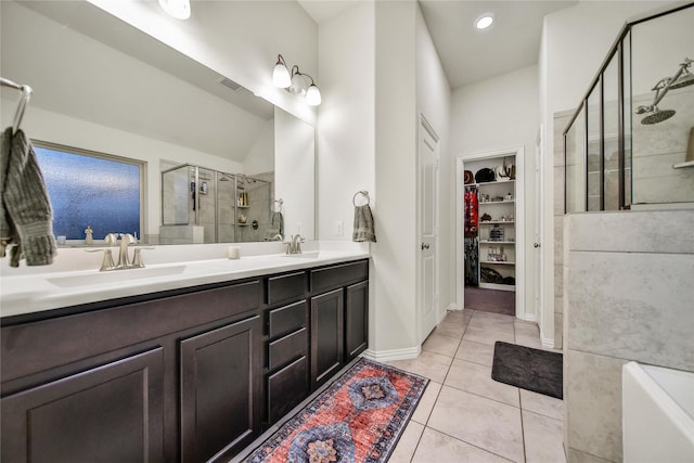7411 Nottington Ct, Spring, TX 77379 - full bathroom featuring a stall shower, a spacious closet, double vanity, tile patterned flooring, and a bathtub