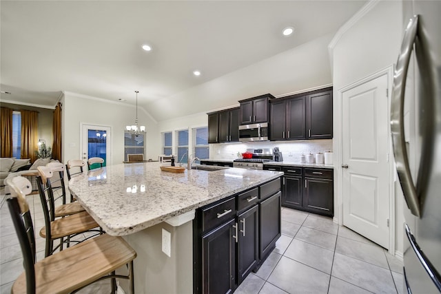 7411 Nottington Ct, Spring, TX 77379 - kitchen featuring appliances with stainless steel finishes, a breakfast bar, a chandelier, light stone countertops, and crown molding