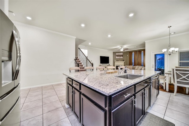 7411 Nottington Ct, Spring, TX 77379 - kitchen featuring appliances with stainless steel finishes, ceiling fan, crown molding, light tile patterned flooring, and decorative light fixtures