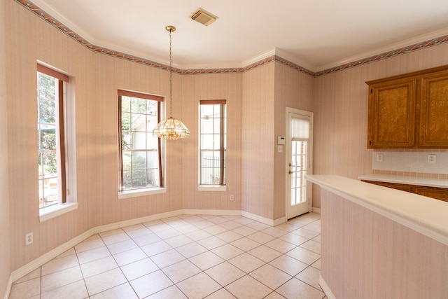2107 Enchanted Lake Dr, League City, TX 77573 - unfurnished dining area with crown molding, light tile patterned flooring, a chandelier, and baseboards