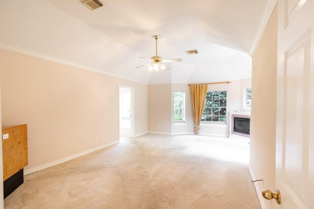 2107 Enchanted Lake Dr, League City, TX 77573 - unfurnished living room featuring a tiled fireplace, light carpet, lofted ceiling, a ceiling fan, and baseboards