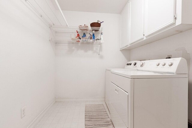 2107 Enchanted Lake Dr, League City, TX 77573 - laundry room featuring cabinet space, washing machine and dryer, and baseboards