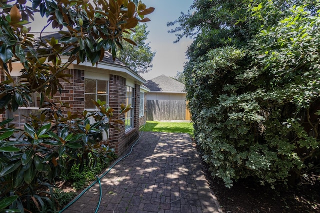 2107 Enchanted Lake Dr, League City, TX 77573 - view of side of home with brick siding and a patio