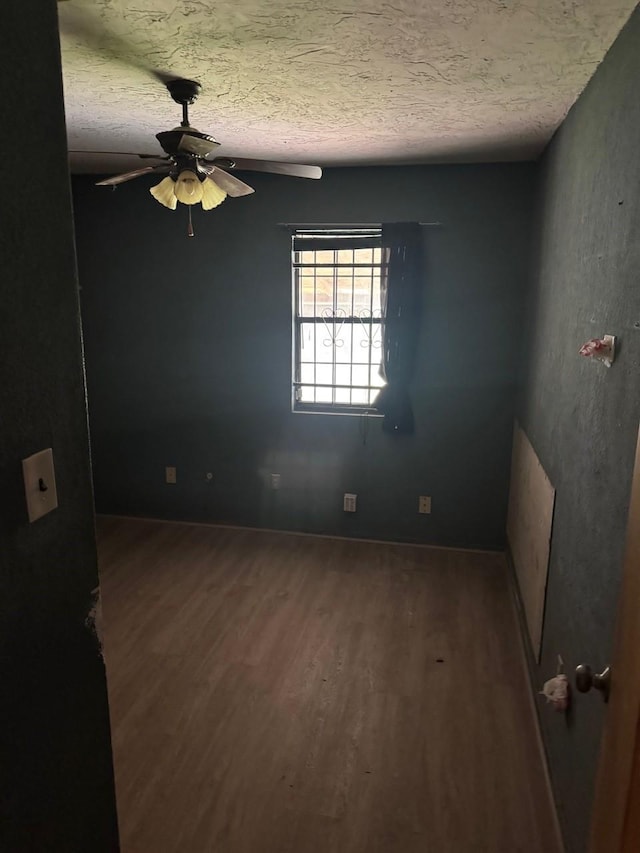 710 Fields St, Richmond, TX 77469 - empty room with wood finished floors, ceiling fan, and a textured ceiling