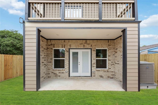 5608 Hollow Pines Dr, Houston, TX 77049 - view of exterior entry featuring a balcony, brick siding, a patio, and french doors