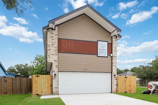 5608 Hollow Pines Dr, Houston, TX 77049 - contemporary home featuring an attached garage, driveway, a gate, and brick siding